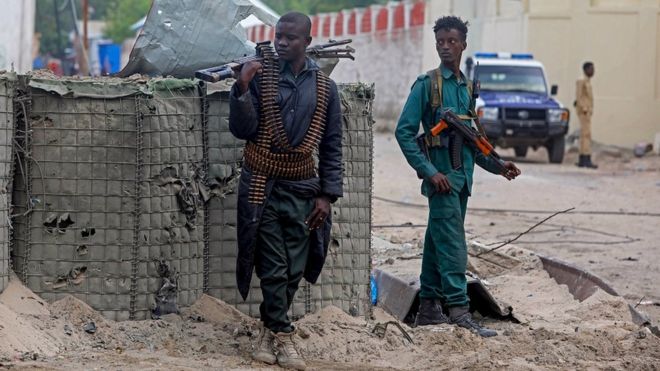 Two soldiers at the scene of the blast in Mogadishu
