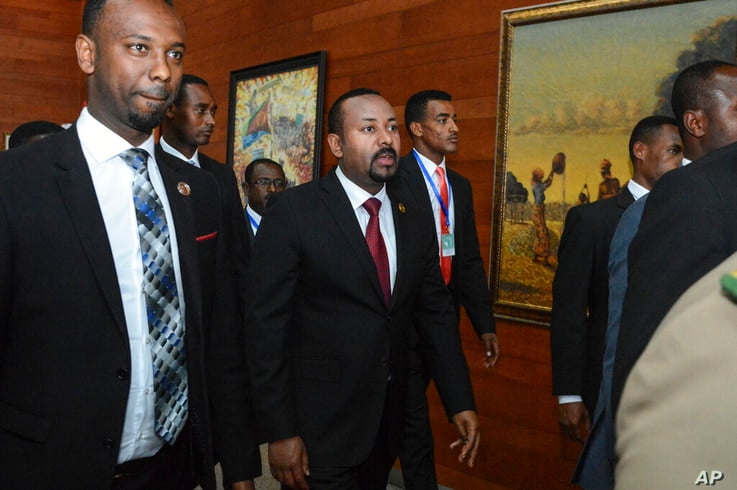 FILE - In this Sunday, Feb. 9, 2020, file photo, Ethiopia's Prime Minister Abiy Ahmed, center, arrives for the opening session…